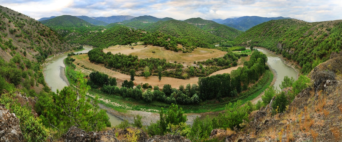 A river winding through a valley surrounded by hills.