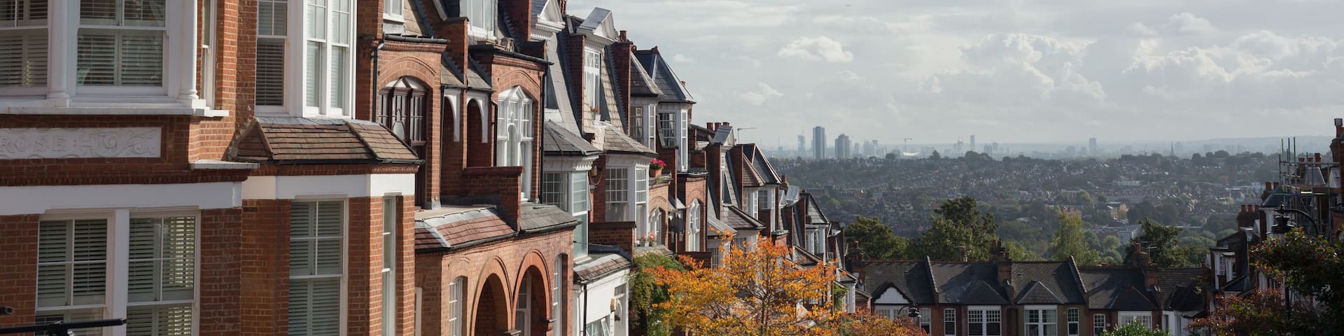 Brick houses of Muswell Hill and panorama of London with Canary Wharf, London, UK