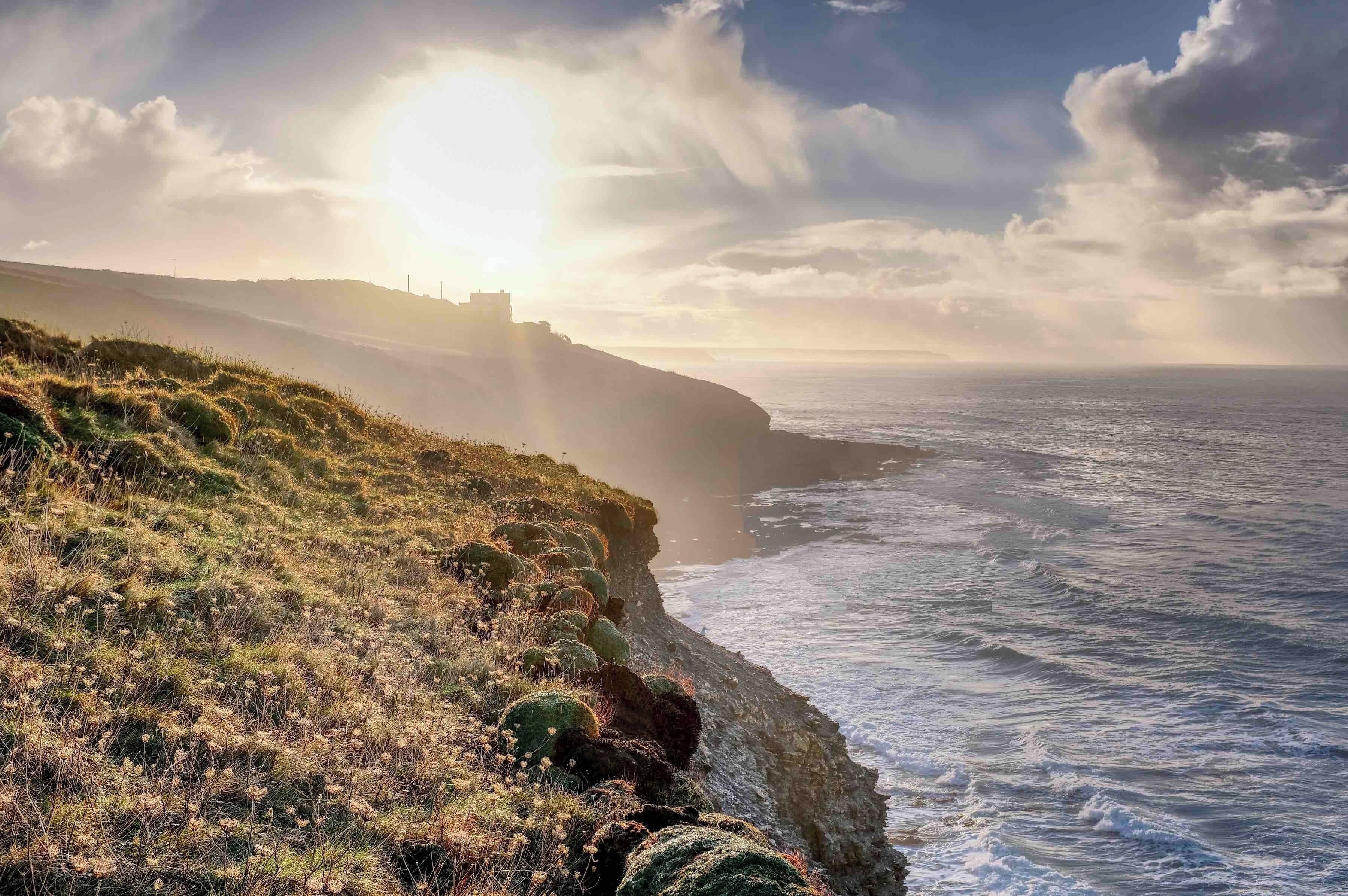 A view looking east into the morning sun, towards Porthleven from the SW Coast path