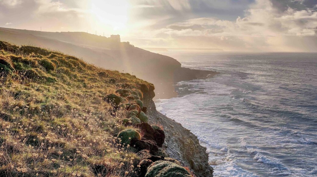 A view looking east into the morning sun, towards Porthleven from the SW Coast path