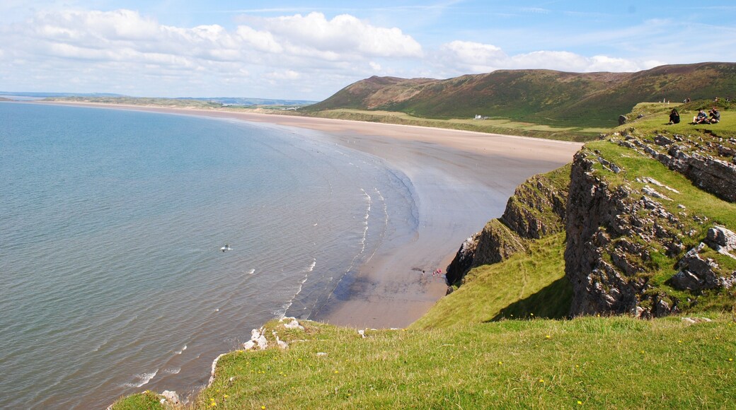 Rhossili is located at the most Western part of the Gower Peninsula. The most photographed part of Gower, The Worms Head, stretches out to sea and becomes an island when the tide comes in. The breathtaking view is completed by the long sandy beach and the towering cliffs and this makes it a popular destination throughout the year with surfers, paragliders and ramblers. However, Rhossili still manages to maintain its tranquility and unspoilt beauty.
#BeachTips
