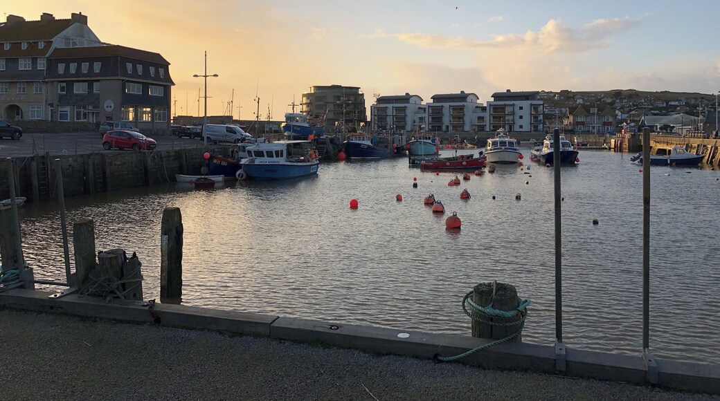 The boats in he harbour and the sun going down makes a colourful photo.