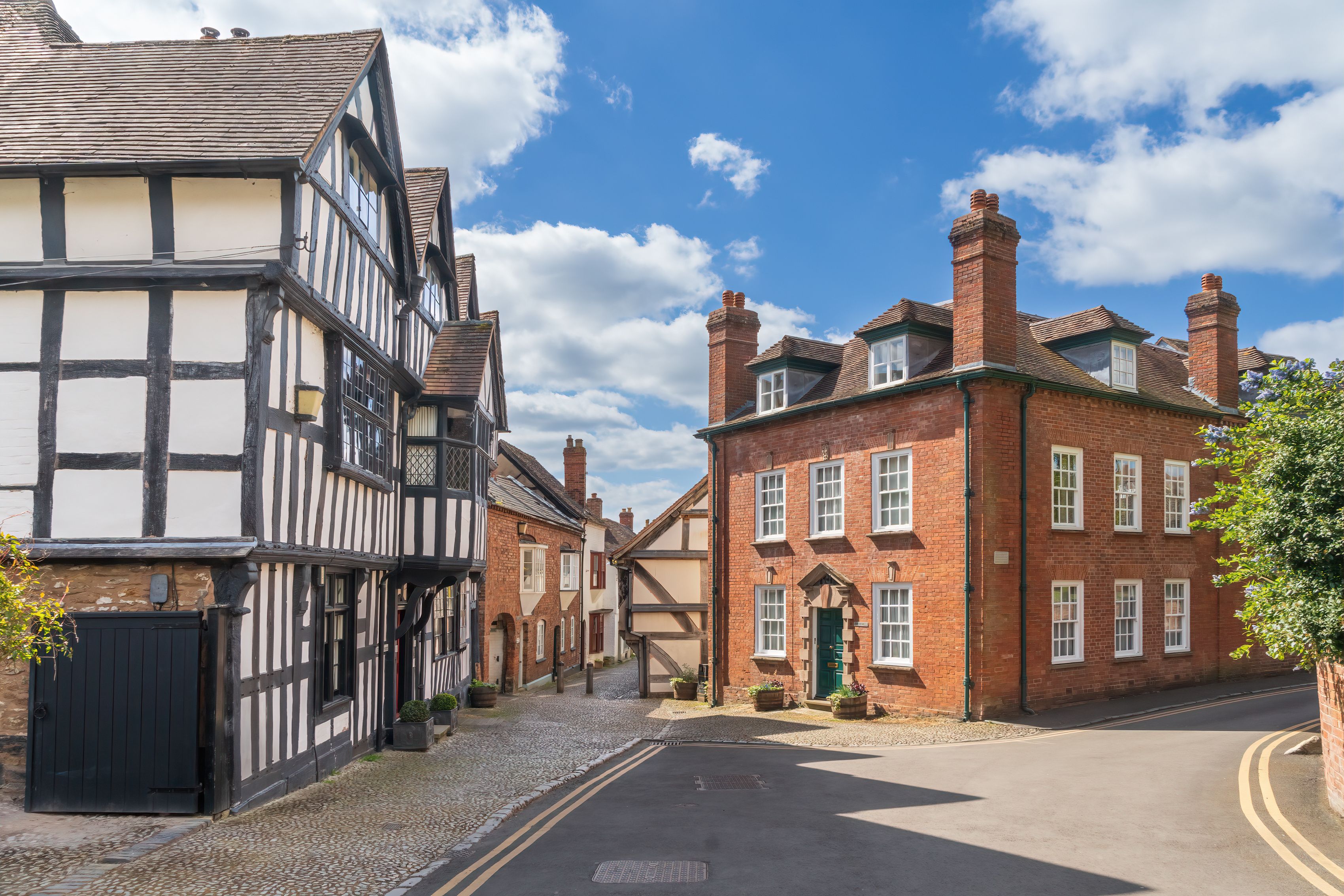 A street lined with traditional half-timbered houses and red brick buildings.