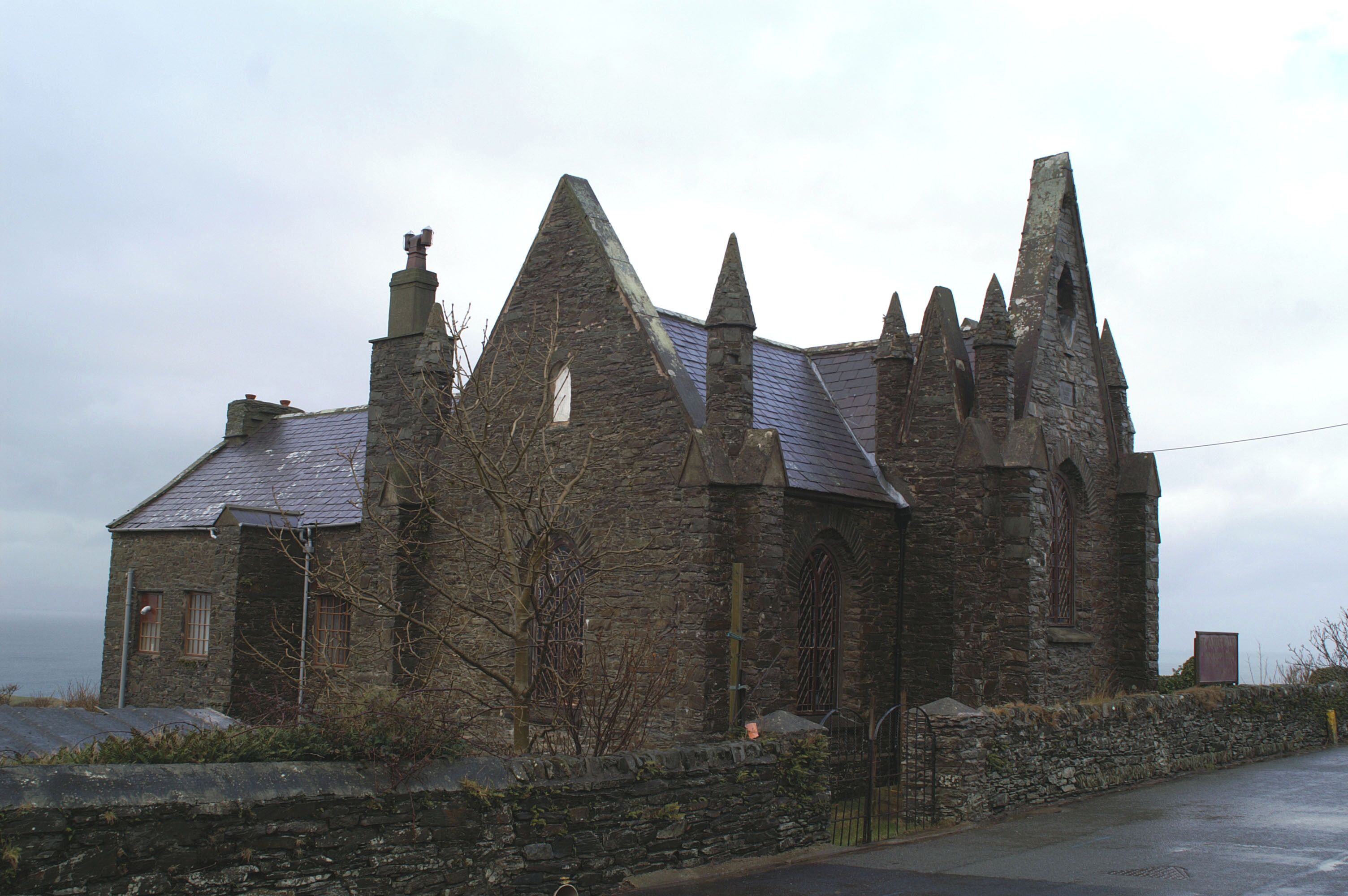 This is NOT a chapel! The gothic pinnacles appear to have been added to this otherwise plain building as if to emphasise that it is a Church, not a Chapel. St James' CofE, Dalby.