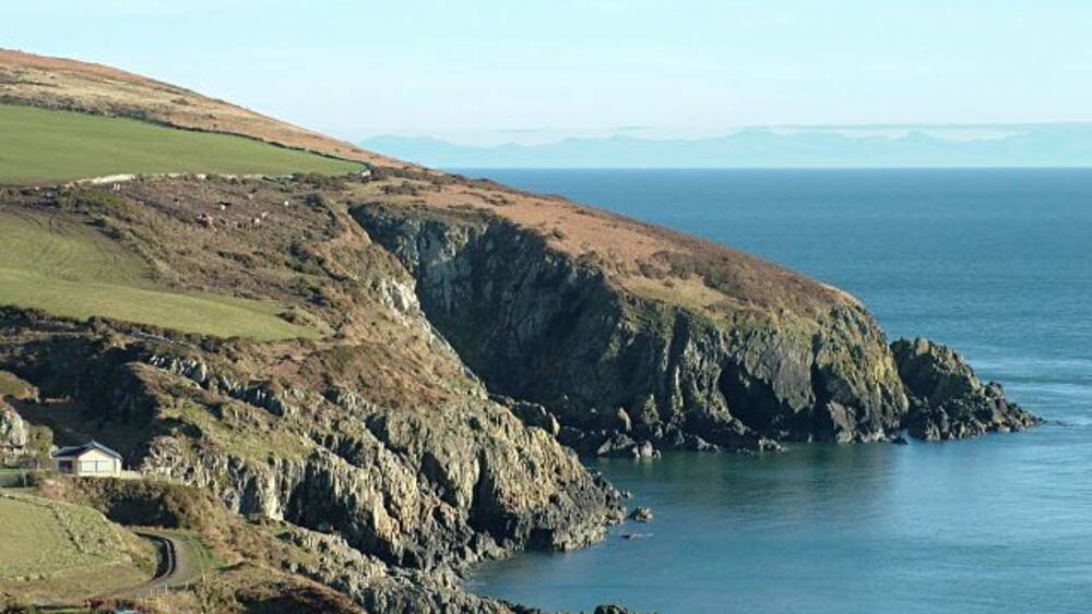 Groudle Headland - Isle of Man. Picture taken from the south side of Groudle Glen, with the mountains of the English Lake District visible on the horizon. The tracks of the Groudle Glen Railway can also be seen.