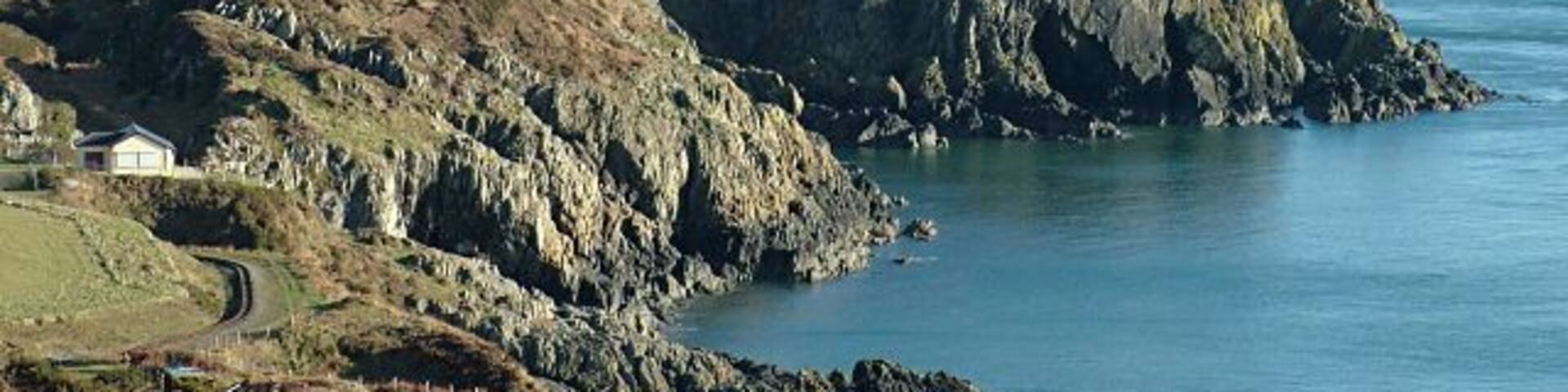 Groudle Headland - Isle of Man. Picture taken from the south side of Groudle Glen, with the mountains of the English Lake District visible on the horizon. The tracks of the Groudle Glen Railway can also be seen.
