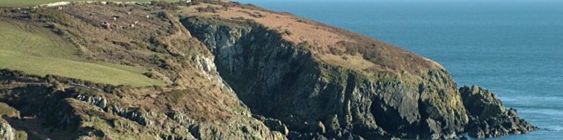 Groudle Headland - Isle of Man. Picture taken from the south side of Groudle Glen, with the mountains of the English Lake District visible on the horizon. The tracks of the Groudle Glen Railway can also be seen.