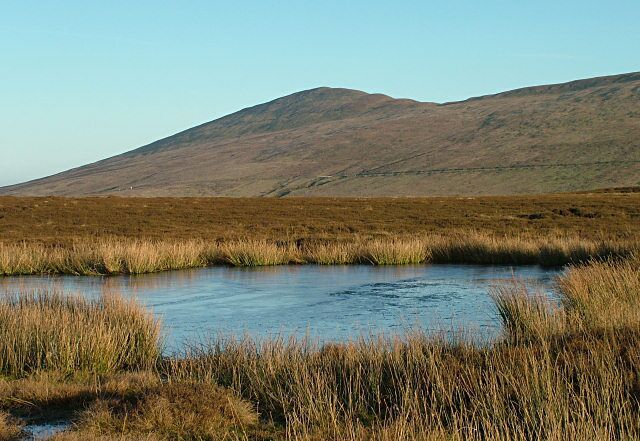 Above Glen Auldyn - Isle of Man. This pool is on 'the tops' with very marshy ground surrounding it. North Barrule is in the background.