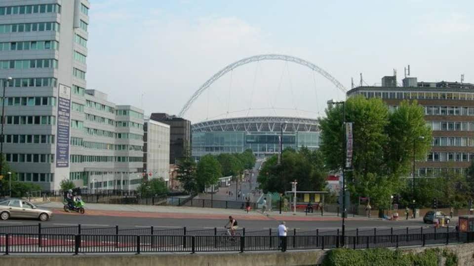 View from top of steps, Wembley Park Station Looking across Wembley Park Drive / Bridge Road, and looking towards Olympic Way and Wembley Stadium. There is a subway at the bottom of the steps which leads to Olympic Way ahead.