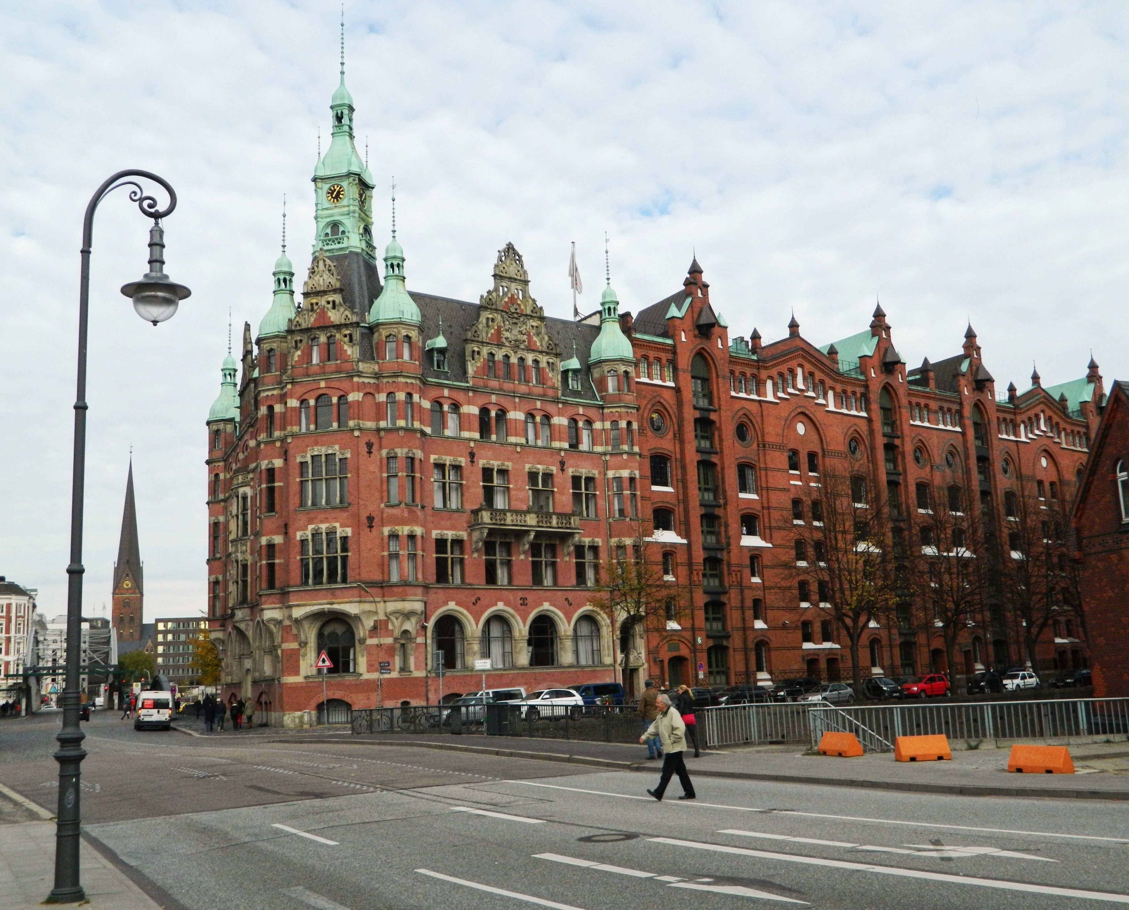 A historic red brick building with ornate architecture and a clock tower.