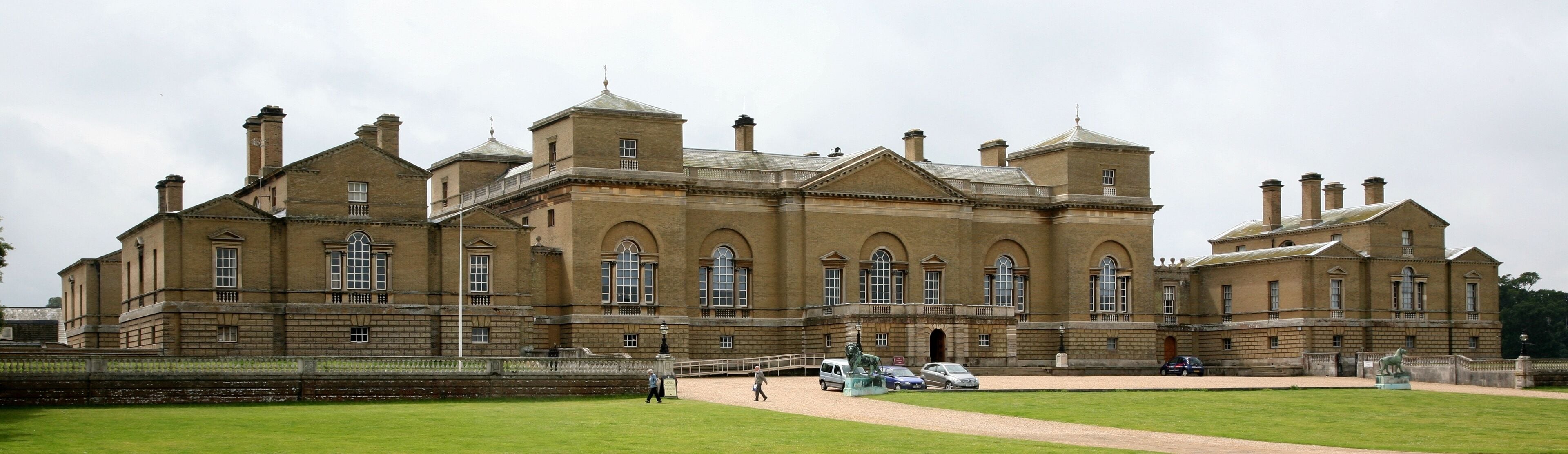 A large, historic building with multiple towers and arched windows.