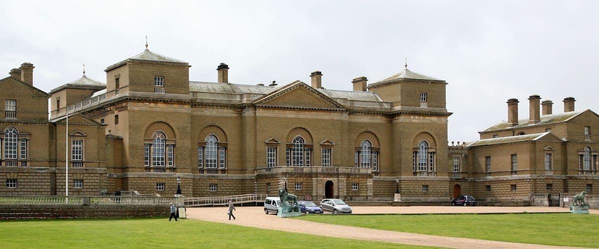 A large, historic building with multiple towers and arched windows.