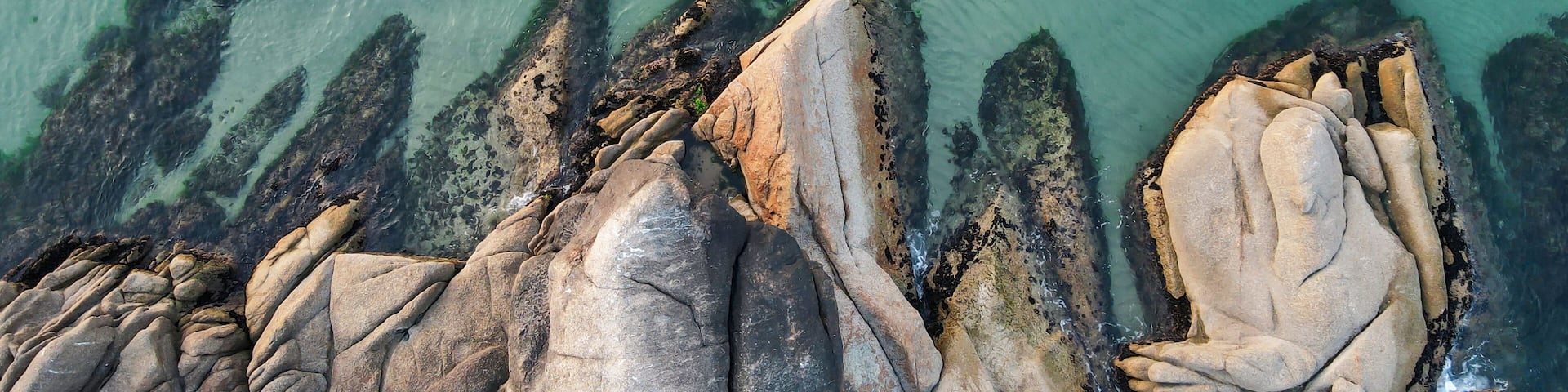 Aerial view of rocks, cliffs and turquoise ocean, beautiful natural background.