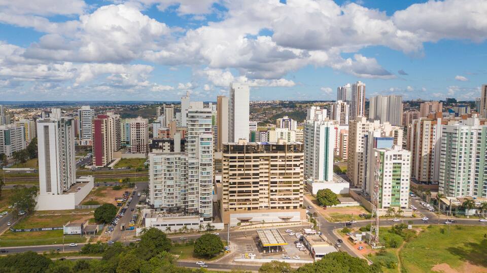 A cityscape with high-rise buildings, roads, and a clear sky.