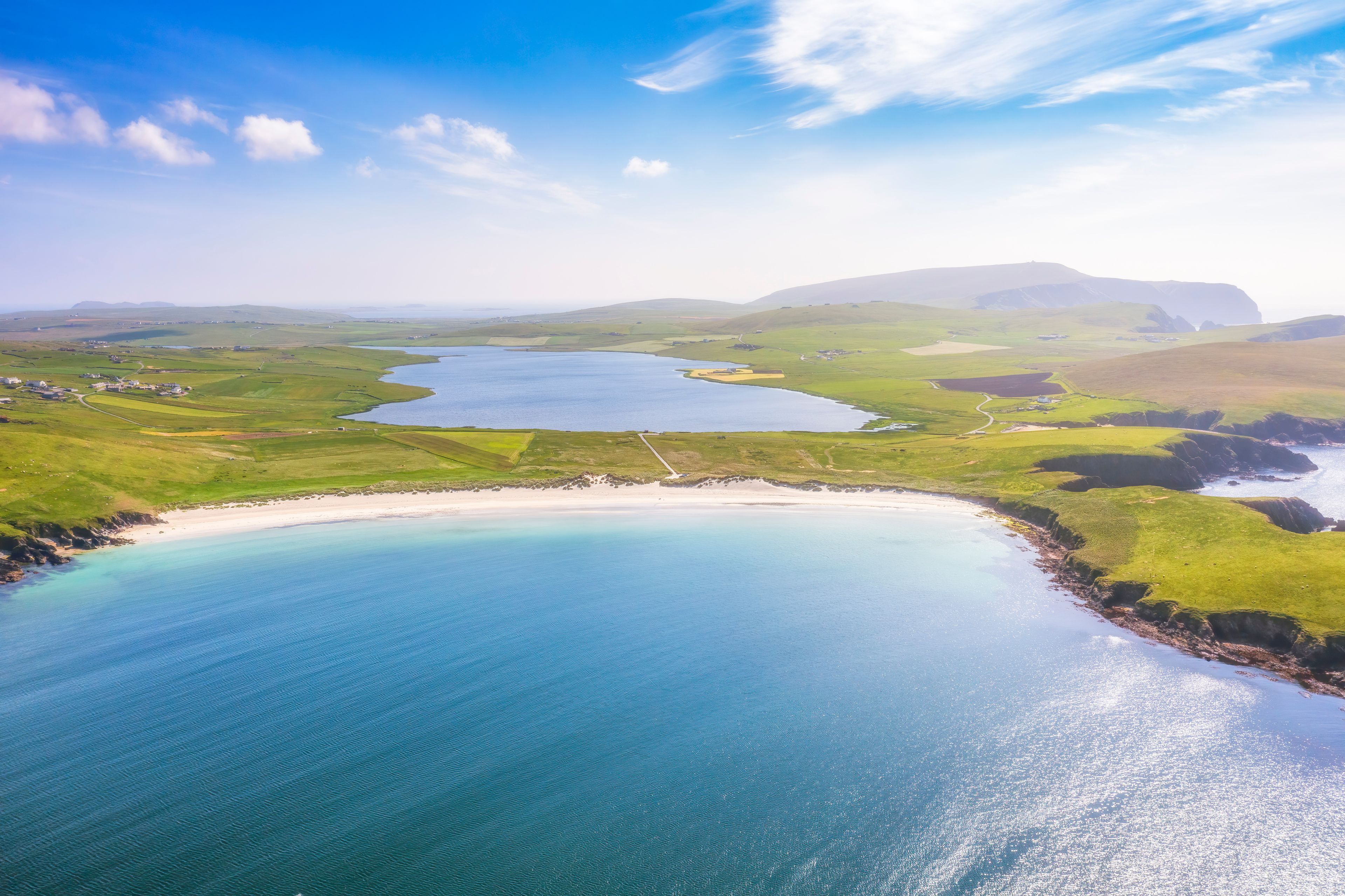 UK, Scotland, Aerial view of Scousburgh Sands in summer with Scousburgh Loch in background