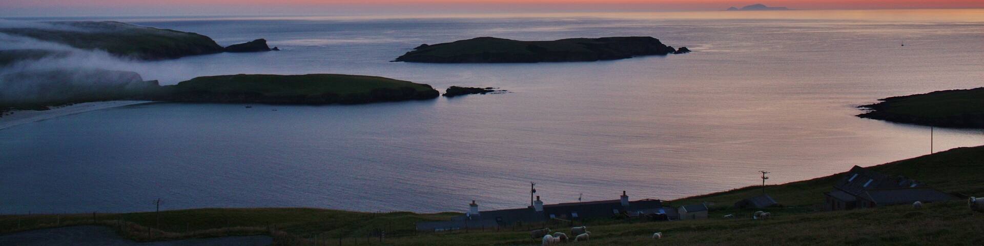 Looking out over the the small island of Colsa and distant Foula.