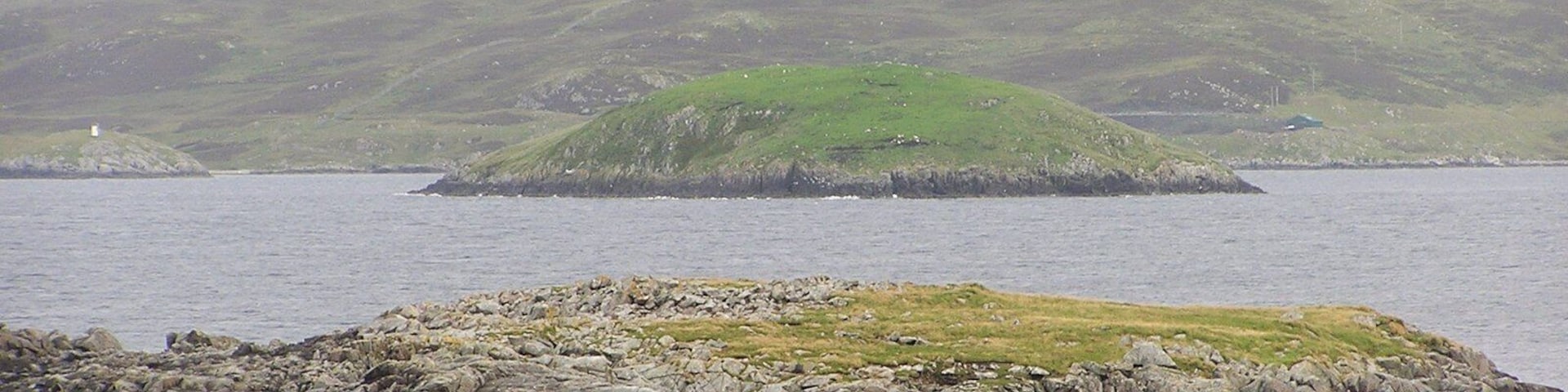 Atla Holm As seen from Fugla Ness on Burra. In the foreground is Scarva Taing with Green Holm HU3837 in the distance.