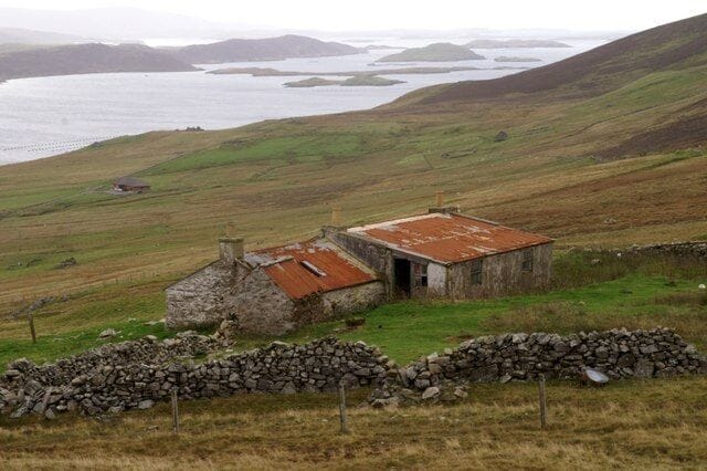 Scord of Sound An abandoned croft above Weisdale Voe. The islands at the mouth of the voe can be seen in the distance.
