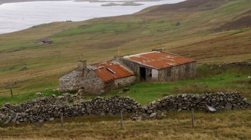 Scord of Sound An abandoned croft above Weisdale Voe. The islands at the mouth of the voe can be seen in the distance.
