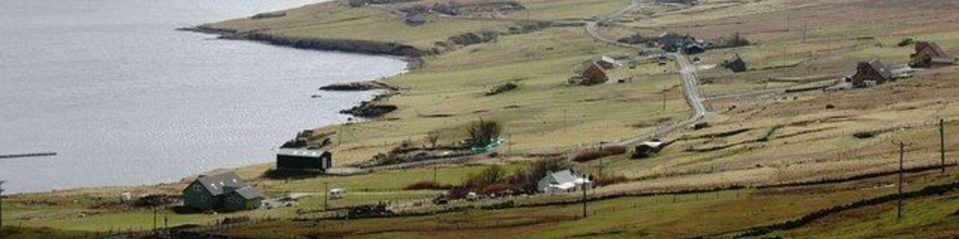 Cott, Weisdale Voe, Shetland. Looking south across the community of Cott on the east side of Russaness Hill and down Weisdale Voe with the islands of Greena, Flotta and the Hoggs of Hoy in the distance.