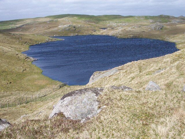Mill Loch, Lunna Ness. This is one of a group of three lochans to the west of Grutwick. They are surrounded by the rocky hills which make up the spine of this peninsula,