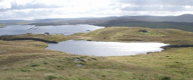 A landscape with multiple lakes and rolling hills.