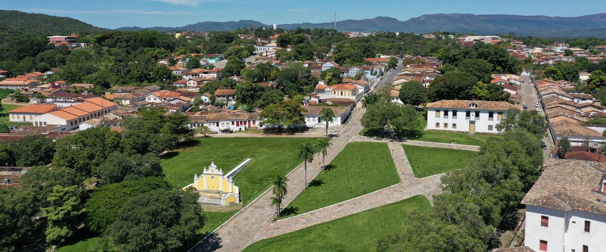 A town with a central square, surrounded by buildings and greenery.