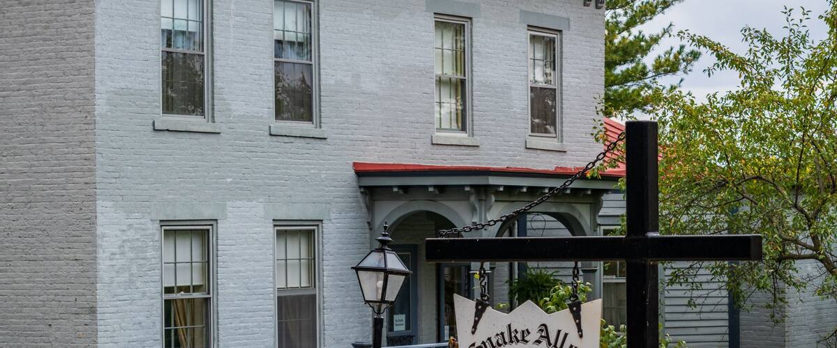 A historic building with a sign reading "Snake Alley Entrance."