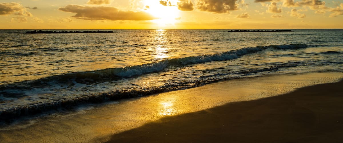 Sunrise over the sea with some Clouds. Golden Hour at the Beach