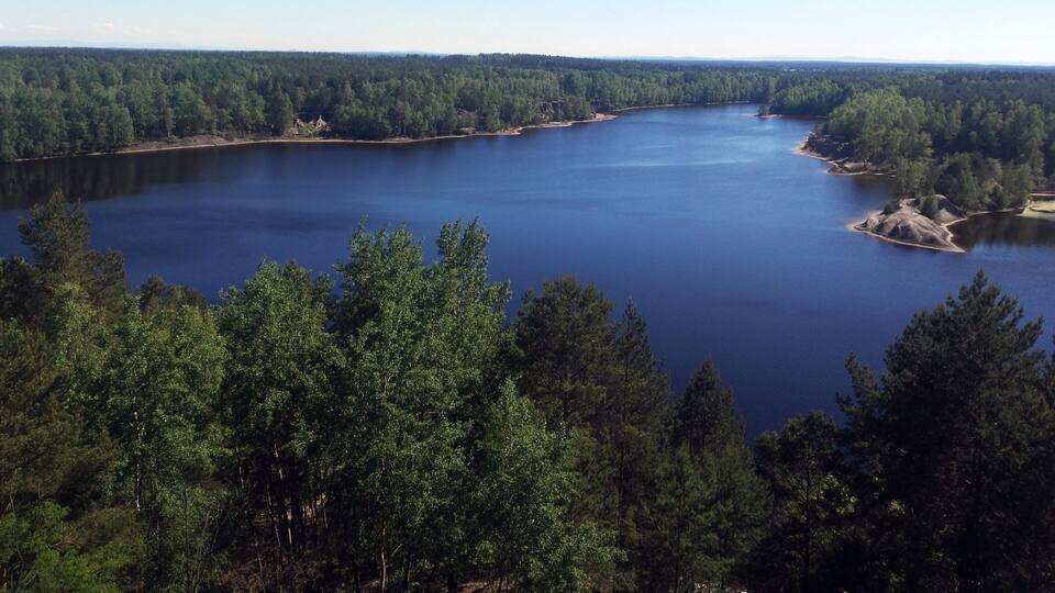 A large lake surrounded by dense forest.