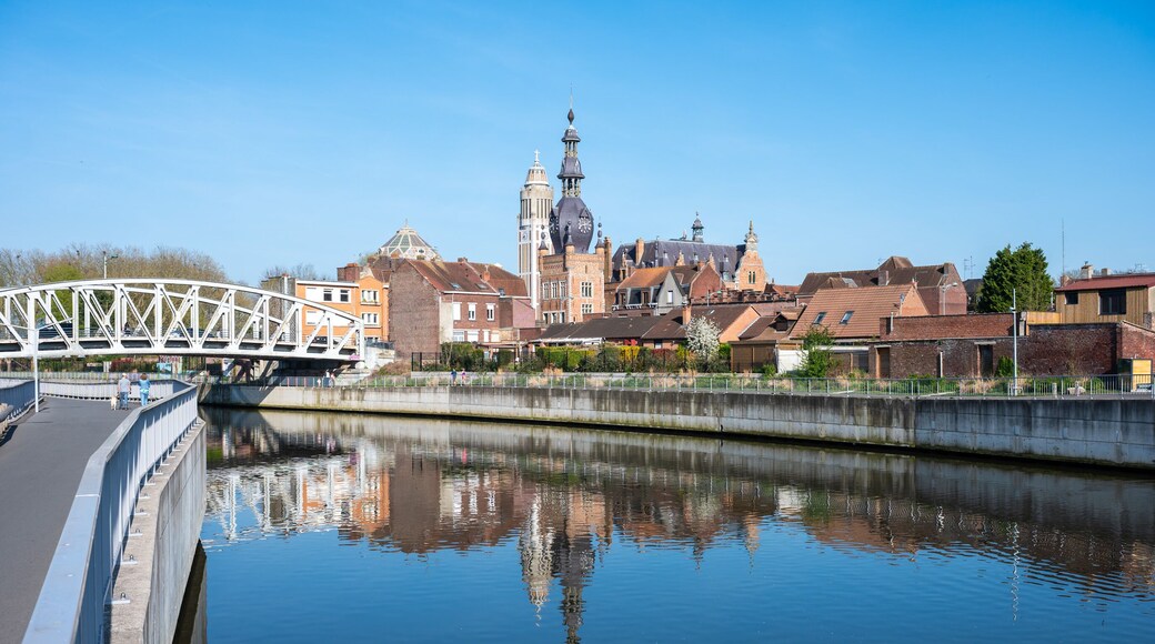 The French city of Comines Hauts De France reflecting in the river Lys or Leie as seen in Comines - Warneton, Hainaut, Belgium