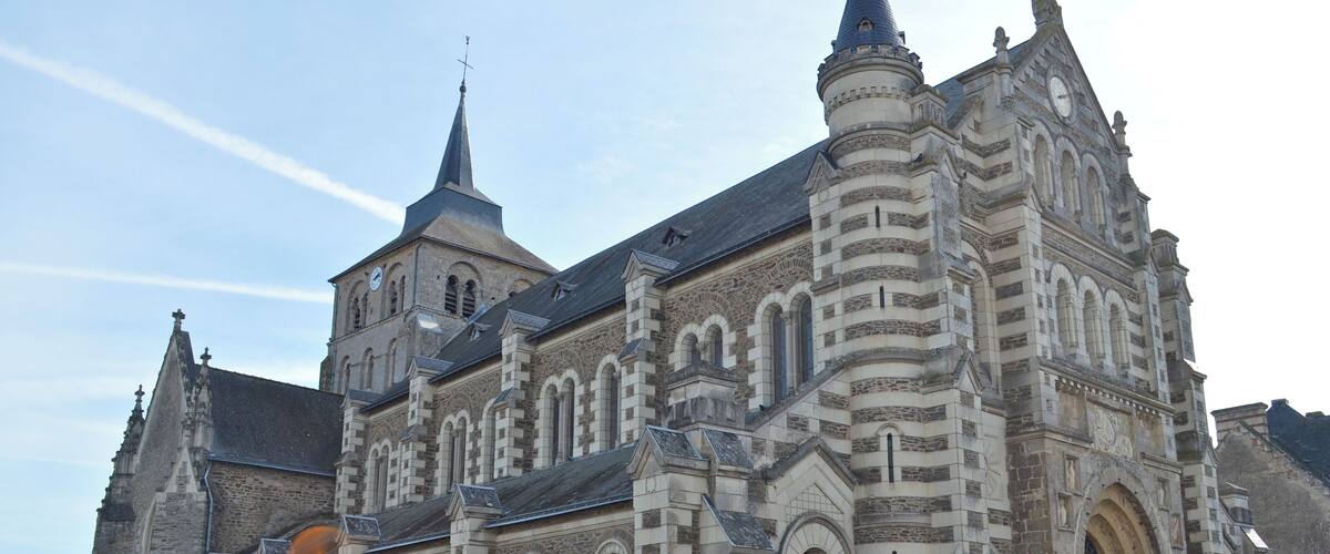A historic church with a clock tower and a large arched entrance.