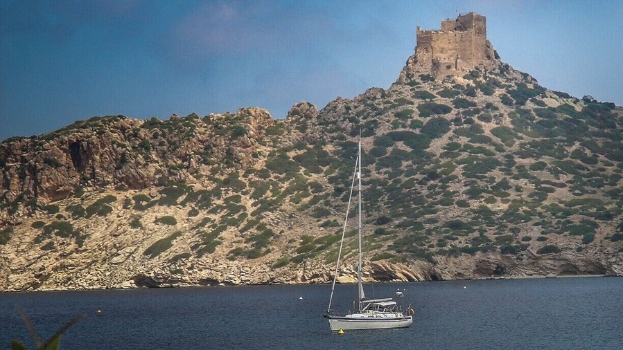 Anchored in the bay of Isla Cabrera, below a castle. This is a Spanish national park near Mallorca in the Balearic Islands.