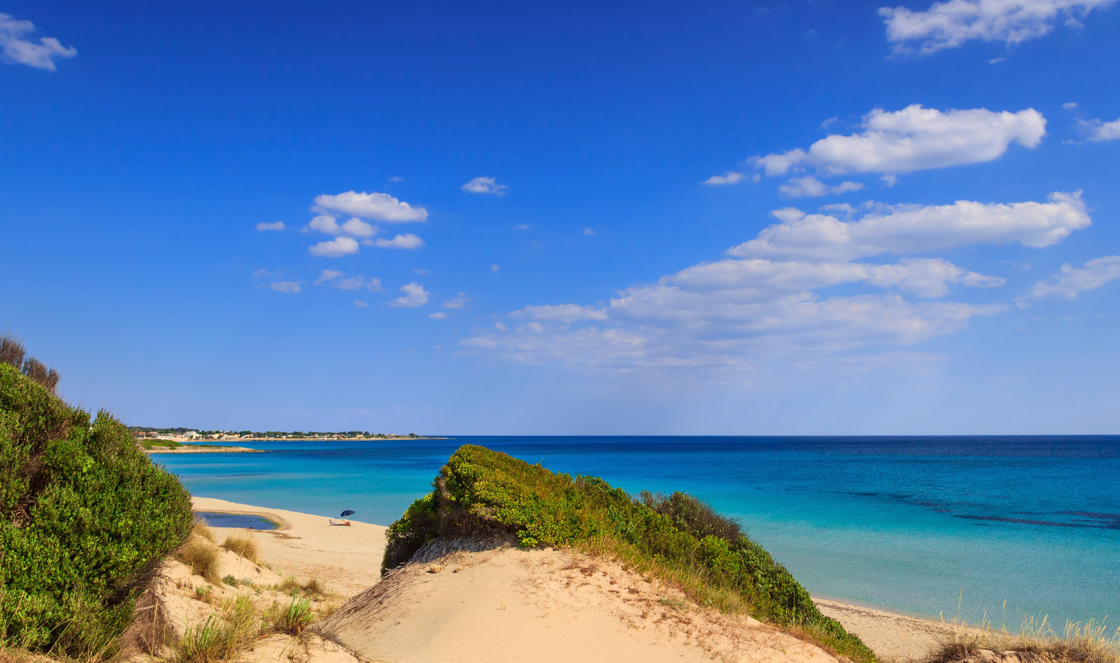 Summer seascape, Apulia coast: Marina di Lizzano beach (Taranto). The coastline is characterized by a alternation of sandy coves and jagged cliffs overlooking a truly clear and crystalline sea.