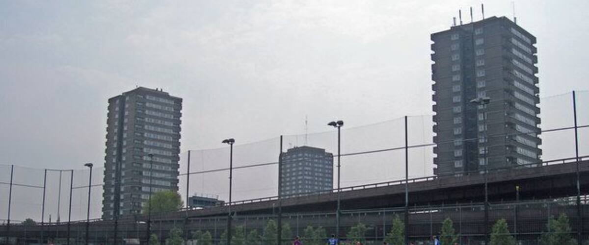 Westway Sports Centre in foreground. In the background are the Westway elevated road, and three tower blocks: Whitstable House, Grenfell Tower (pre-refurbishment) and Dixon House