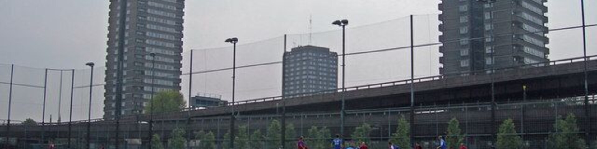 Westway Sports Centre in foreground. In the background are the Westway elevated road, and three tower blocks: Whitstable House, Grenfell Tower (pre-refurbishment) and Dixon House