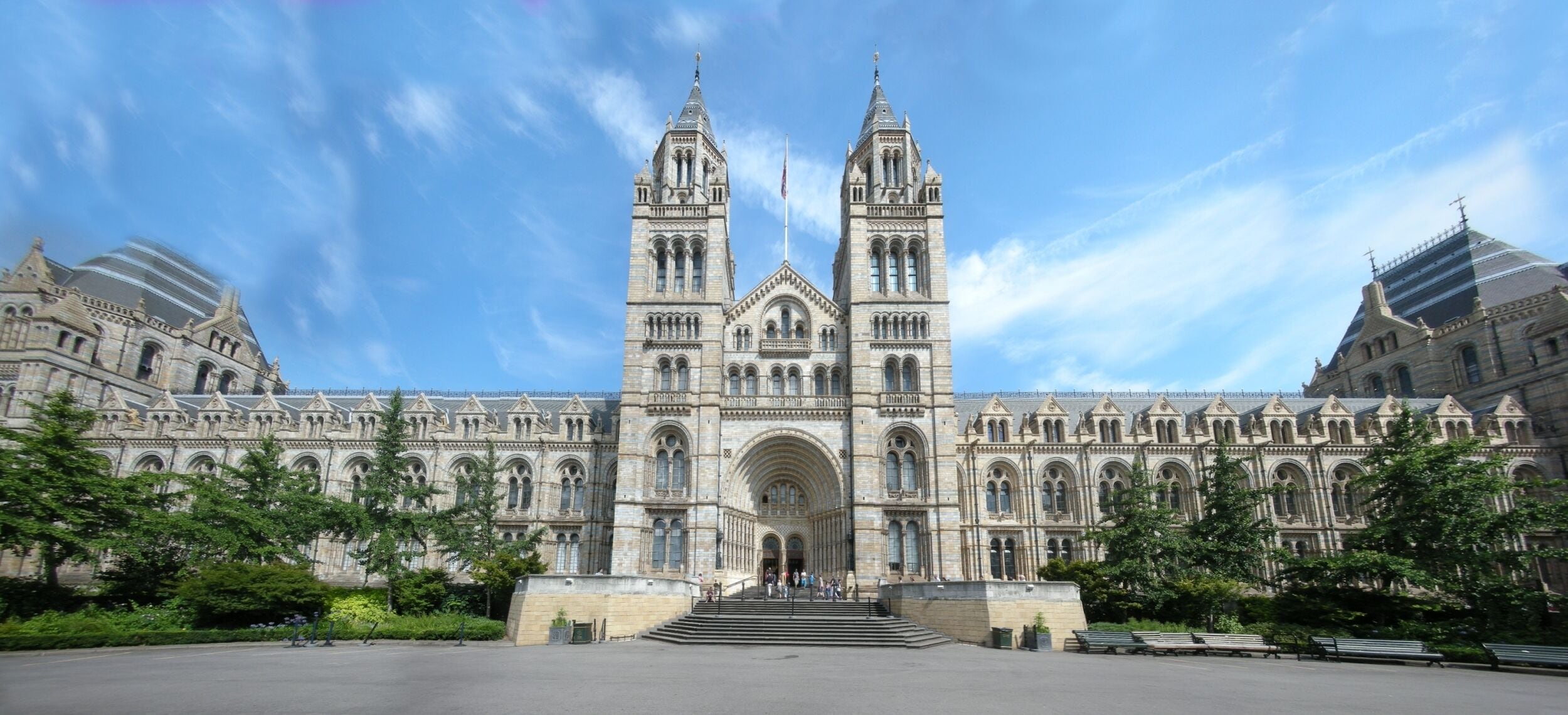 A large, ornate building with two tall towers and a central archway.