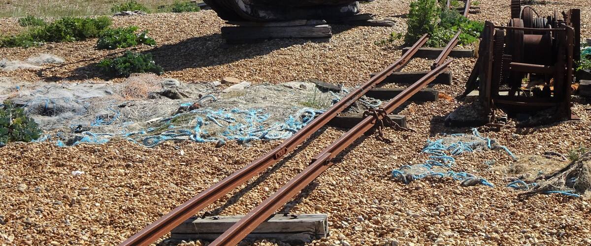 A particular landscape: a huge pebble beach, debris, abandoned and rusted material, in the distance the threatening shape of a huge nuclear power plant, some lonesome wrecks… #LocalSecrets #Trovember