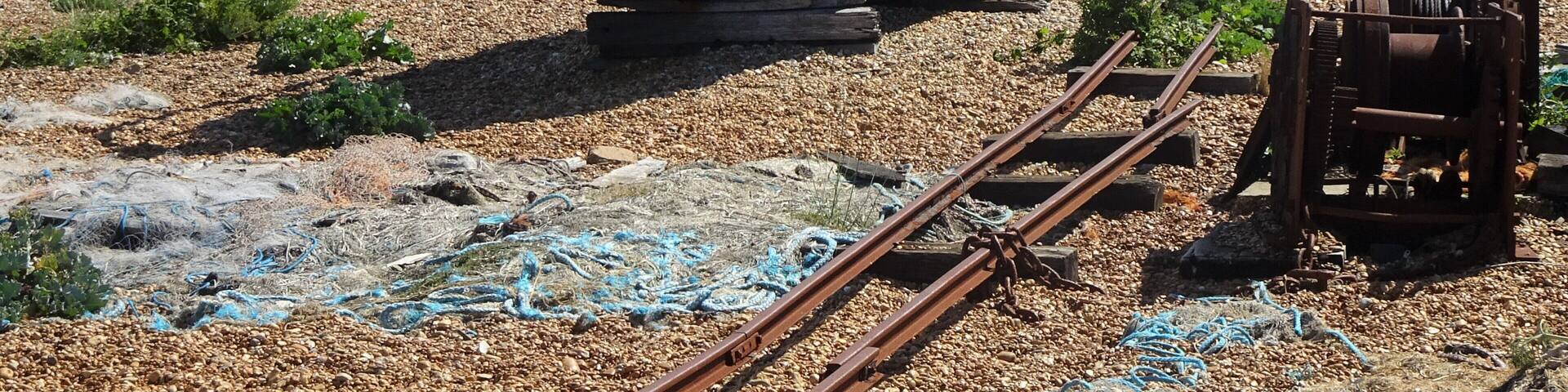 A particular landscape: a huge pebble beach, debris, abandoned and rusted material, in the distance the threatening shape of a huge nuclear power plant, some lonesome wrecks… #LocalSecrets #Trovember