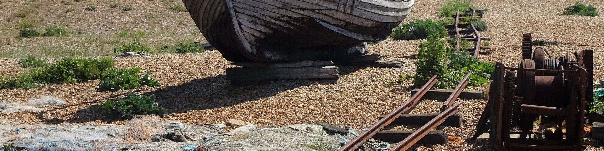 A particular landscape: a huge pebble beach, debris, abandoned and rusted material, in the distance the threatening shape of a huge nuclear power plant, some lonesome wrecks… #LocalSecrets #Trovember