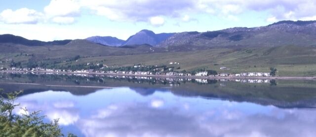 Lochcarron. The village of Lochcarron reflected in the calm waters of Loch Carron.
