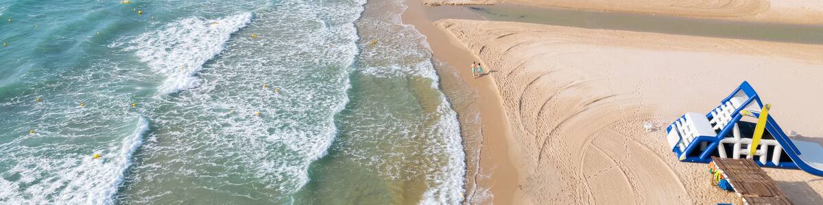 Aerial drone point of view empty beach of Mil Palmeras. Spain