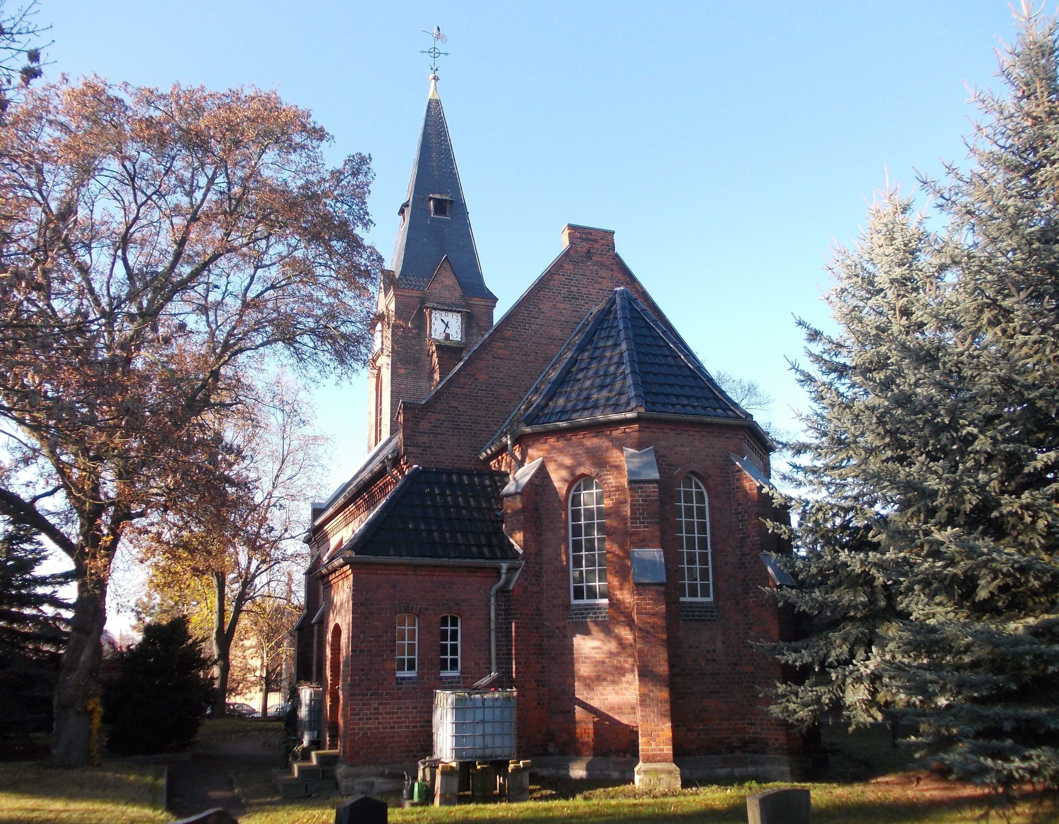 A church with a tall steeple and a clock.