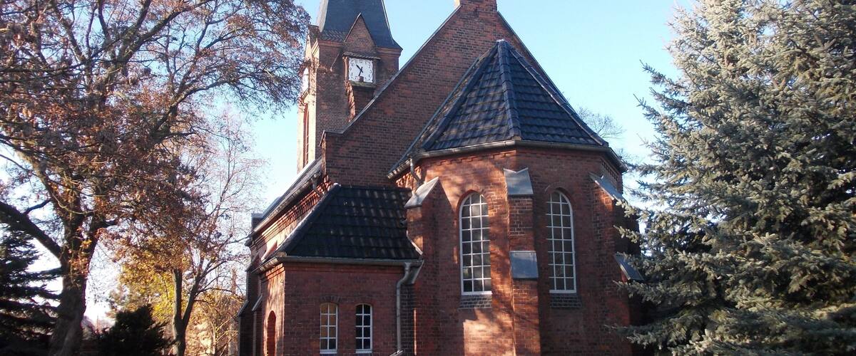 A church with a tall steeple and a clock.