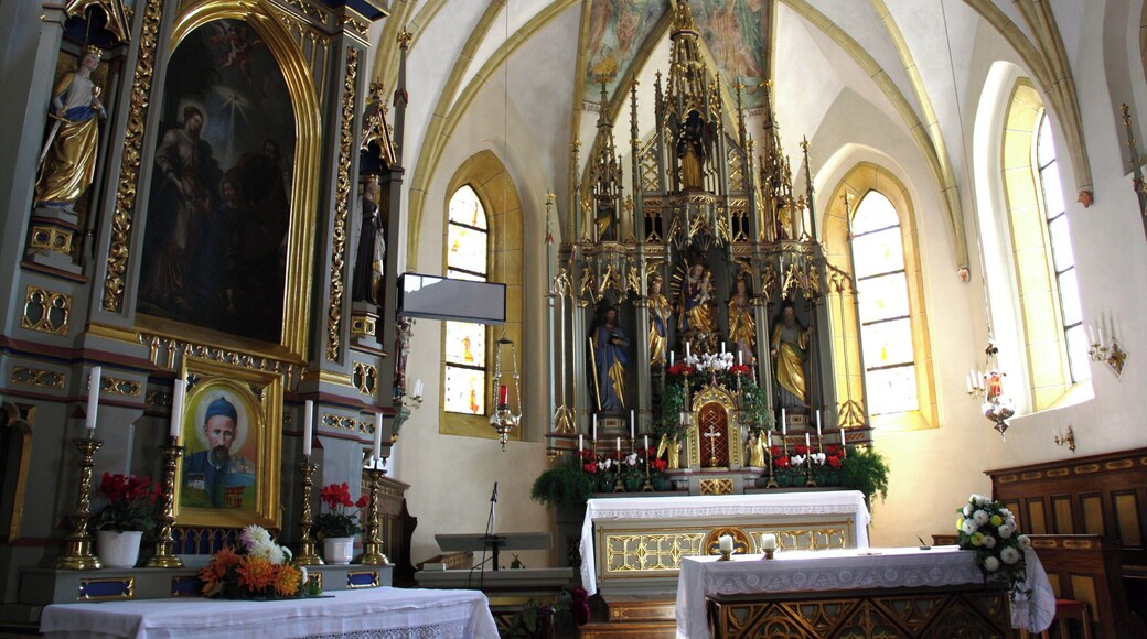 Italy, South Tirol, Natz-Schabs, Schlossergasse, Pfarrkirche Hll. Aposteln Philippus und Jakobus. The first mention of the parish church in Natz dates back to 1157 but the church was consecrated in 1208 by the prince-bishop Konrad von Rodank in honour of Saint Philip and Saint Walpurga. The present church was completed in 1484 in Late Gothic and consecrated once again to the Saints Apostles Philip and James. The bell tower was built in 1400 with granite blocks; in 1635 was damaged by fire and in 1686 was covered with a dome in Baroque style. The high altar is work by Peter Lapper of Natz made in 1855. In the throne of the high altar are the statue of the Madonna, Saint Agnes and Saint Ursula which are Gothc works of 1499 attributed to Michael Parcher; the statues of St. Philip and St. James are by F. X. Renn of Imst made in 1857. The painting of the right lateral altar represent the Baptism of Jesus and the left side altar correspond to the Holy Family, both works are by Michael Lackner of Bruneck. The first organ was installed on May 1st, 1909; the present one has been built by Orgelbau Pirchner of Steinach am Brenner and has 16 registers and 1250 pipes and was inaugurated on May 1st, 1990.