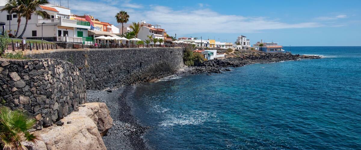 Charming little coastal resort in the south of the island with large promenade lined up with fish restaurants, terraces and bars in La Caleta, Costa Adeje, Tenerife, Canary Islands, Spain