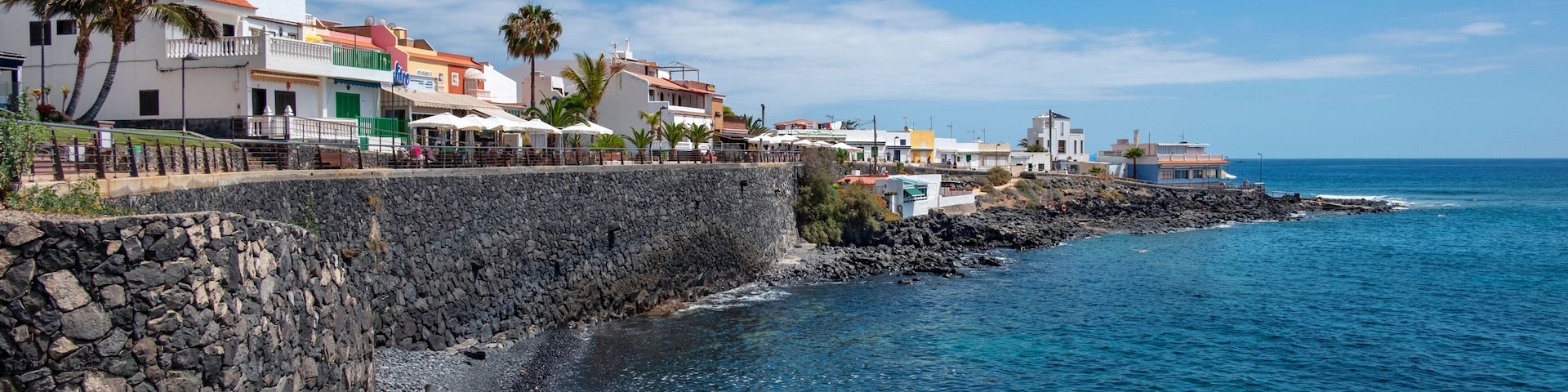 Charming little coastal resort in the south of the island with large promenade lined up with fish restaurants, terraces and bars in La Caleta, Costa Adeje, Tenerife, Canary Islands, Spain