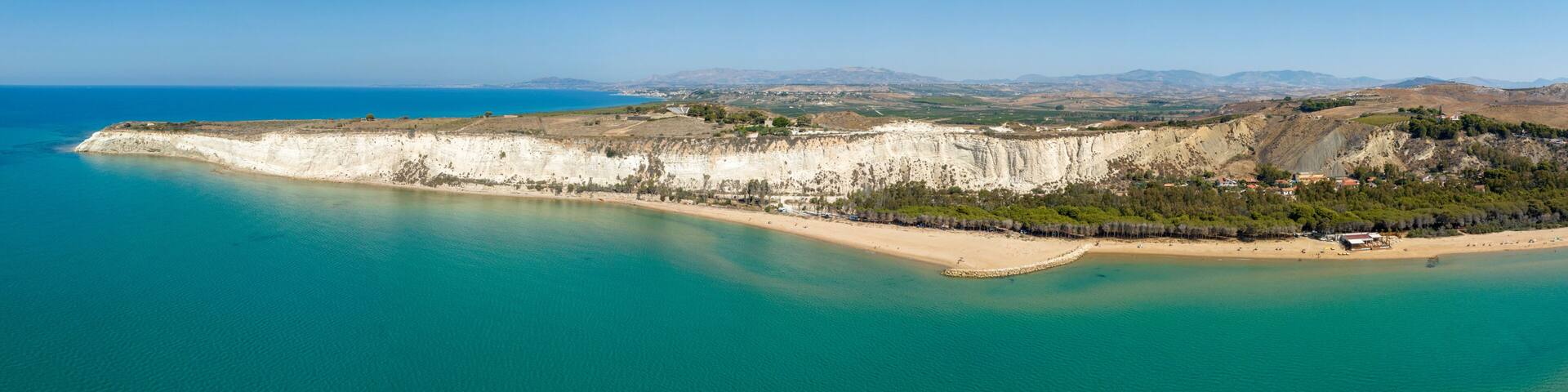 Panoramic aerial view of Eraclea Minoa beach, located in province of Agrigento, Sicily, Italy. It's characterized by a high white cliff. It's a beautiful sunny day. The Mediterranean sea in foreground