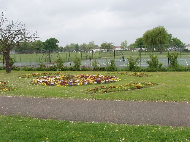 Tennis courts and flower bed, North Acton playing field. This park is mainly used for sport, and this flower bed is one of just a few decorative features. The tennis courts are well used all year, with active tennis coaching particularly of children. See "What A Racket" website http://www.whataracket.com/index.asp