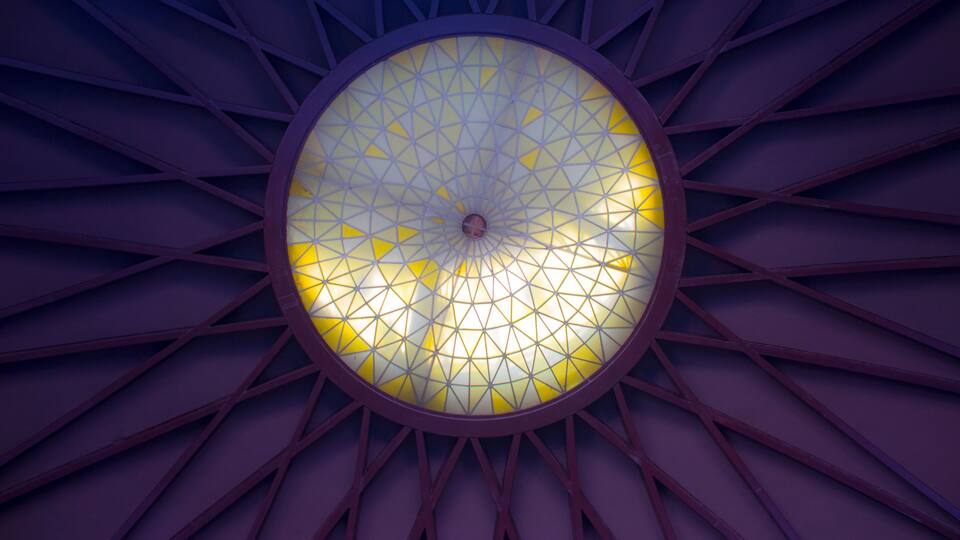 A circular stained glass window with a geometric pattern.